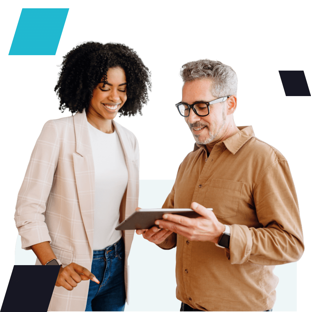 Smiling professionals collaborating over a tablet