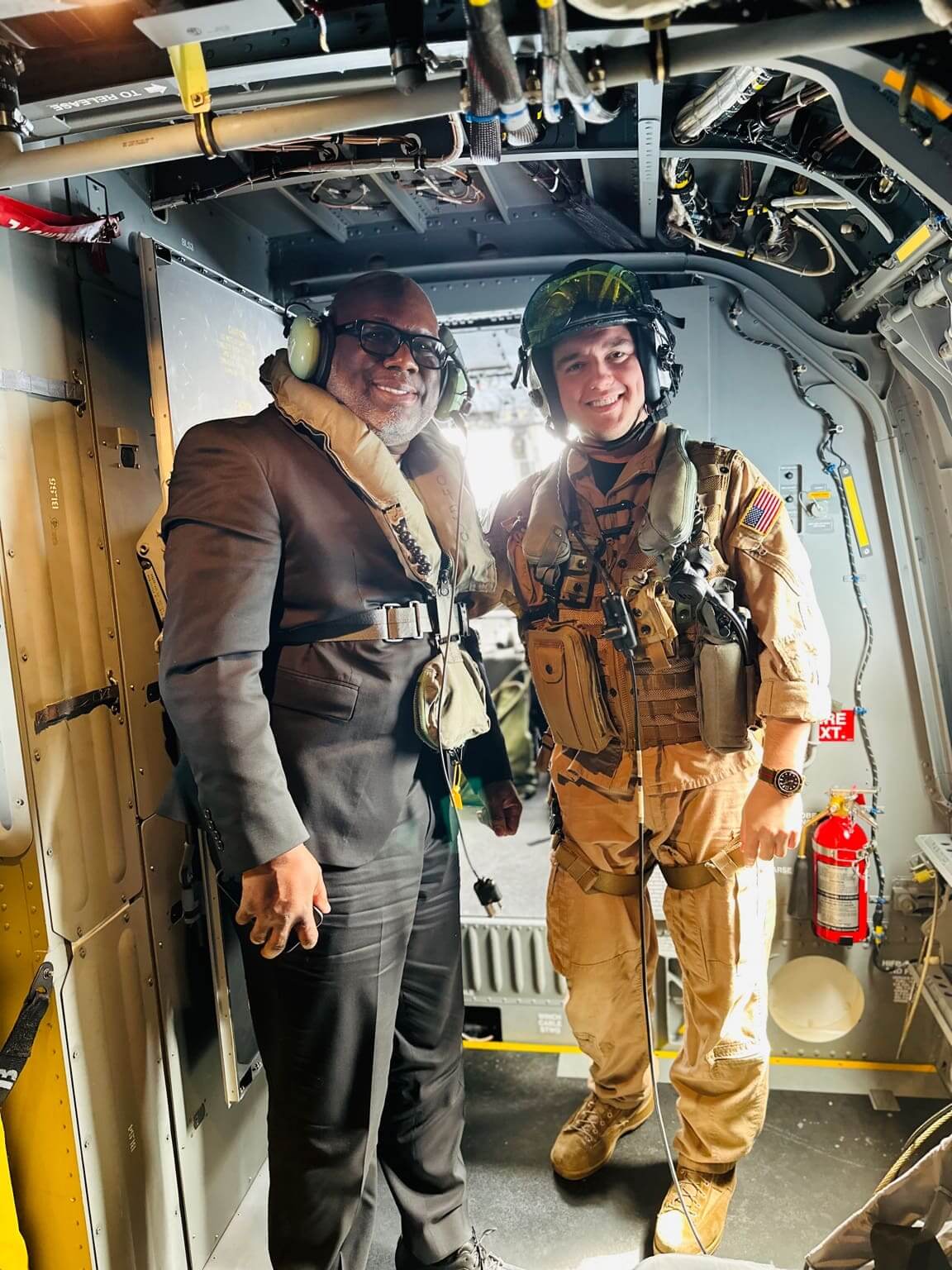 Civilian and soldier inside military helicopter