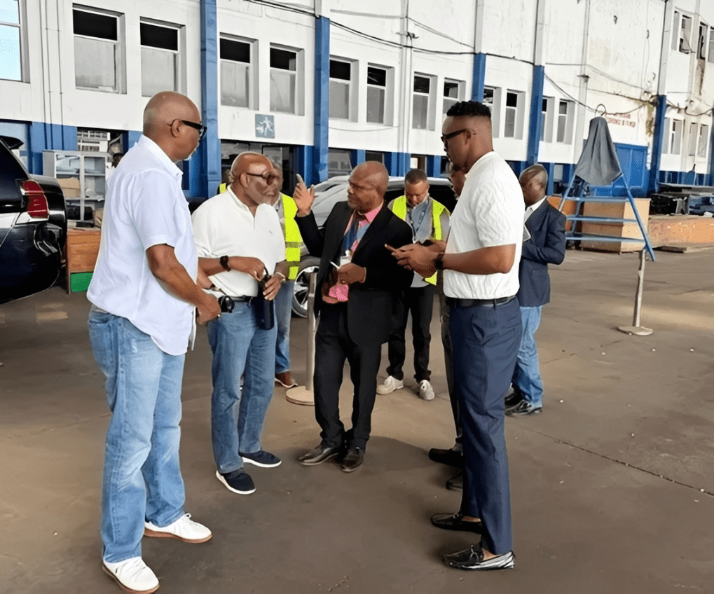 Group of men talking inside industrial building
