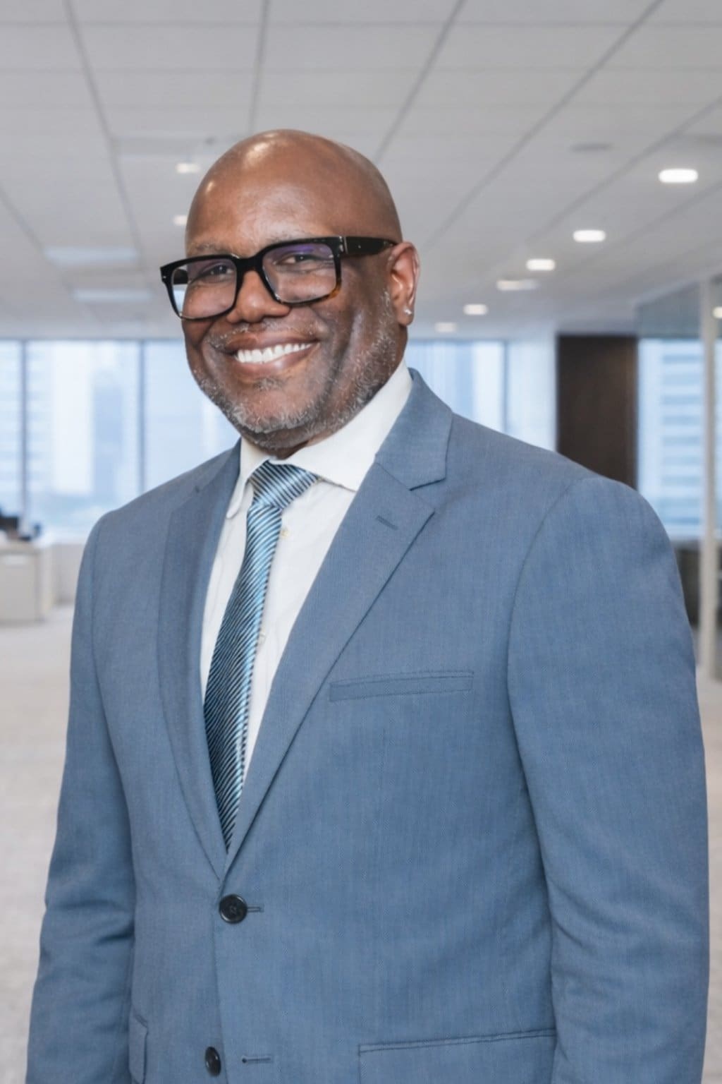 Smiling businessman wearing glasses in office